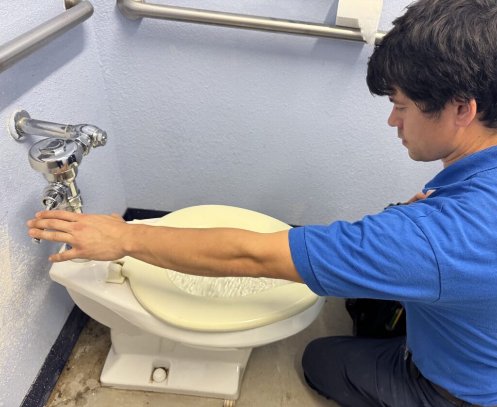 Master Plumber fixing toilet