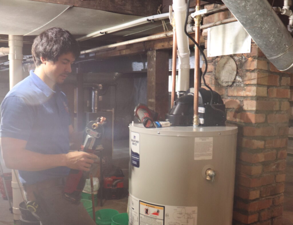 Master plumber installing a water heater.