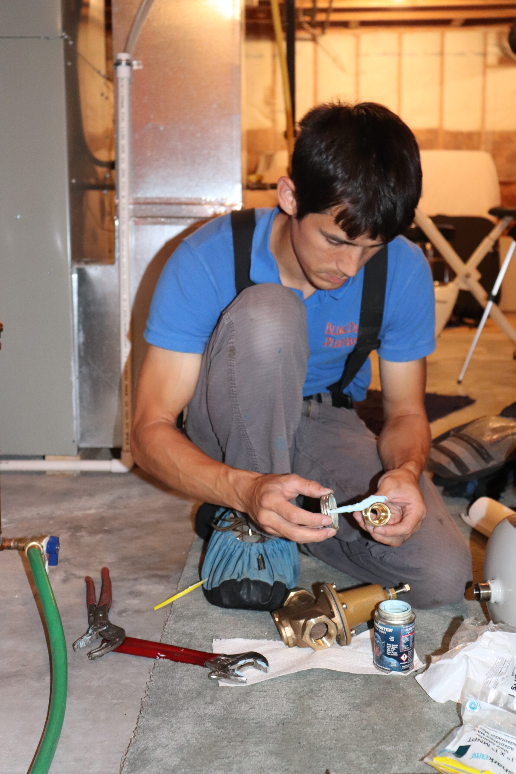 Master Plumber installing new water heater add-on.