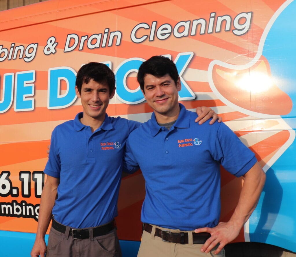 Managers John and Philip standing in front of Blue Duck Plumbing truck.